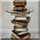 F11. Stacked books end table with glass top. Designed & sculpted by Jaimy. 21”h x 16”w